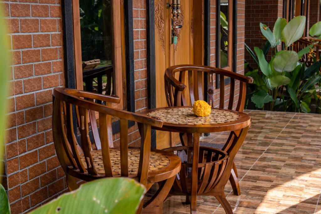 Wooden terrace seating at Yama Villa & Spa Ubud with Balinese-inspired details